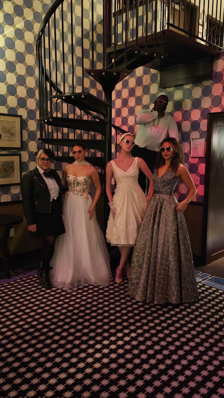 People in wedding attire standing on a checkered floor